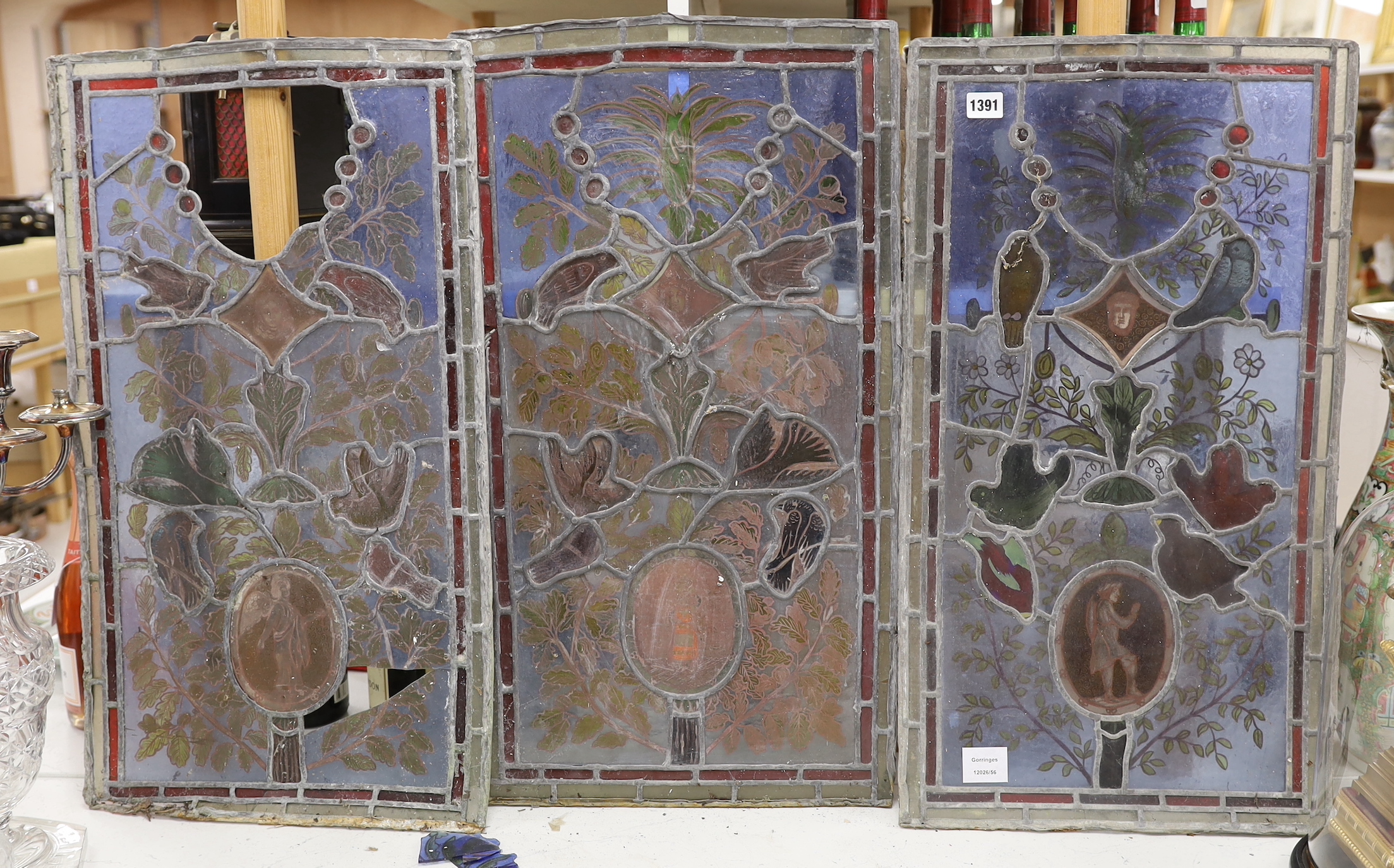 Three stained glass panels of birds and foliage, 71cm high, 39cm wide (a.f.)